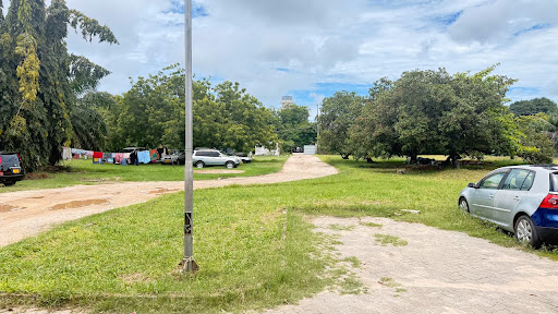 The current open ground at SBT Apartments with patchy grass and bare sandy areas