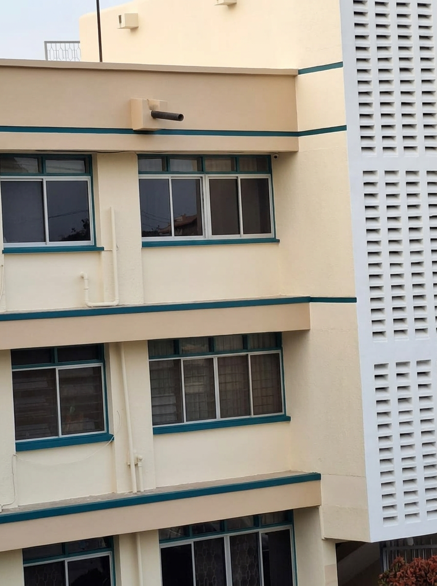 Visualisation of the apartment block repainted in cream with teal accent bands