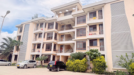 The current new apartment block with faded paint and unmarked parking